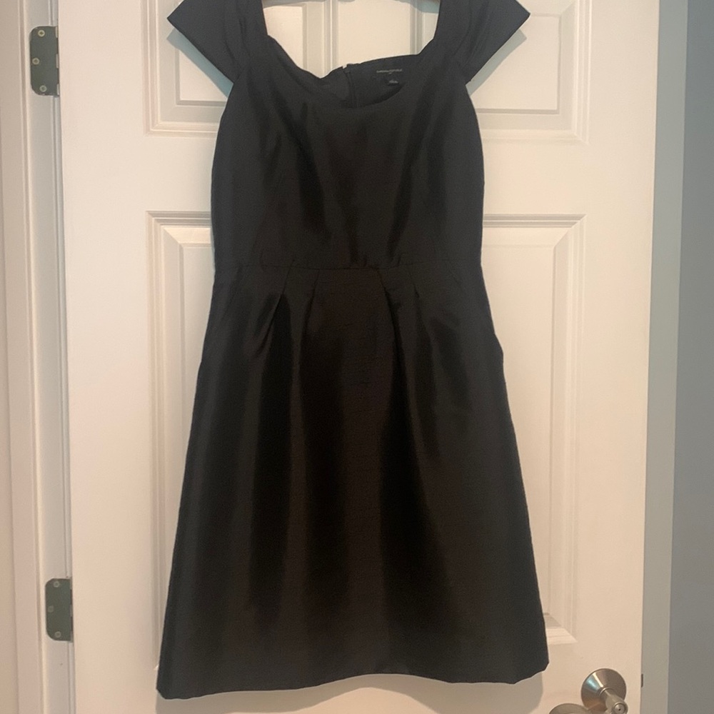 Beautiful black cocktail dress. With pockets pleated waist. Cap sleeve